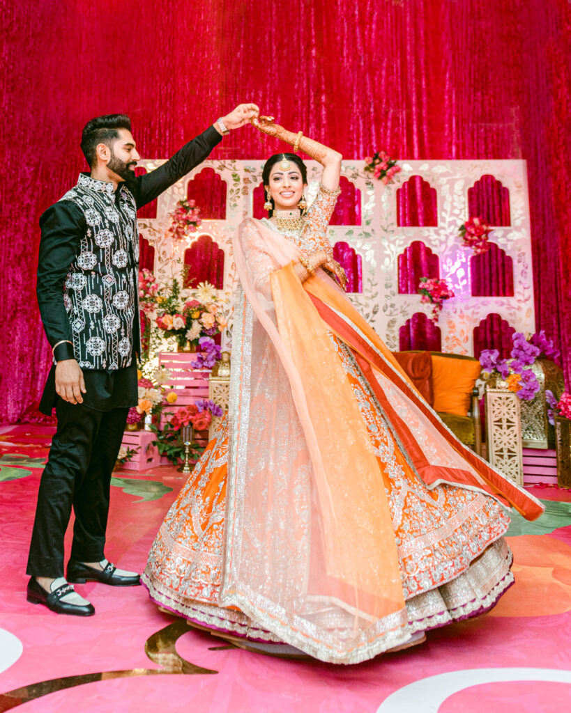 Couple dancing during Sangeet celebration in South Asian wedding traditions