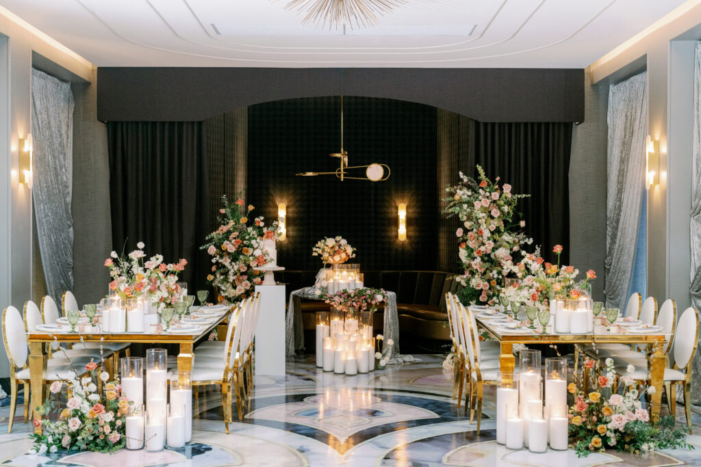 Luxury wedding reception table with gold chairs, floral centerpiece, and elegant place settings