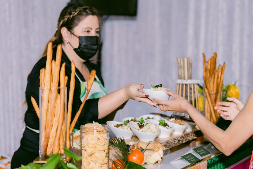 Catering team serving guests during a wedding reception, highlighting vendor coordination by an experienced Sikh Wedding Planner.