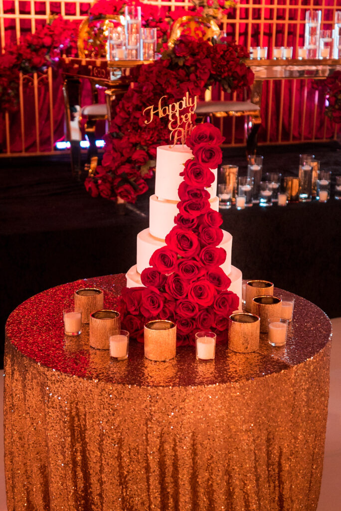 Wedding cake with cascading red roses for a luxury Dubai destination wedding reception