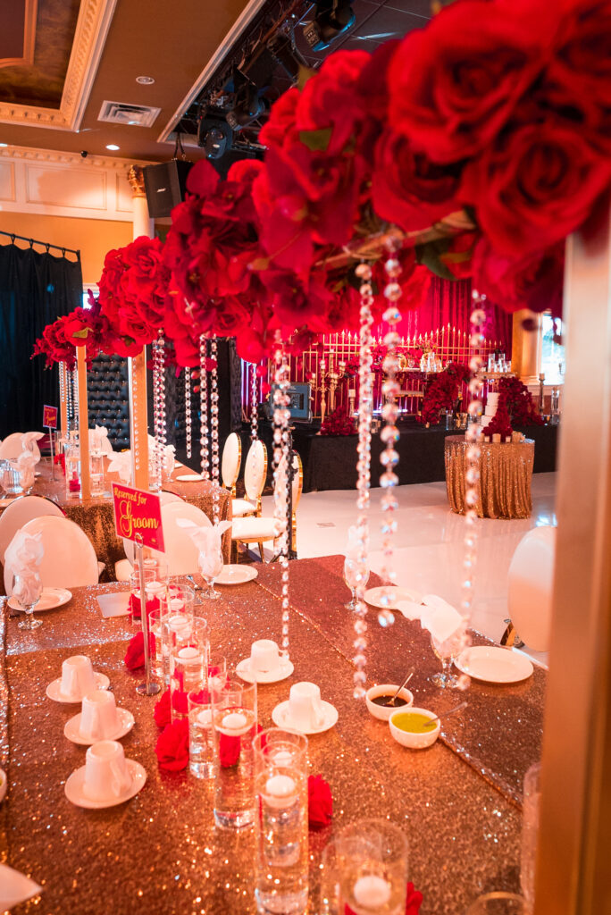 Grand indoor reception decor with chandeliers and floral arrangements for a luxury destination wedding Dubai