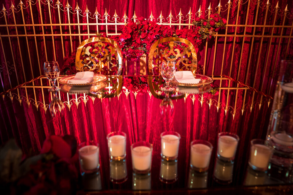 Elegant red and gold reception table styling for a Dubai luxury wedding reception setup