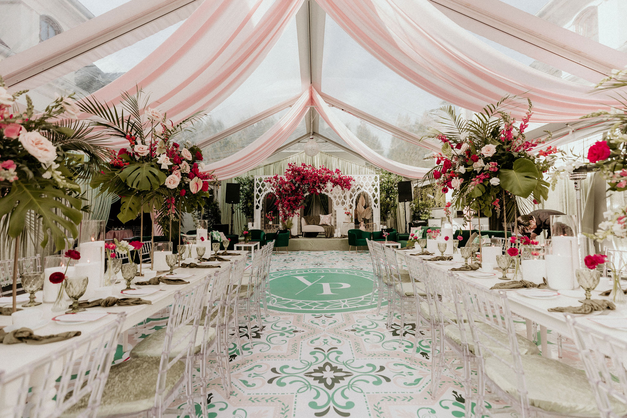Elegant tent reception setup for a luxury destination wedding in Dubai with floral arrangements and draped ceiling