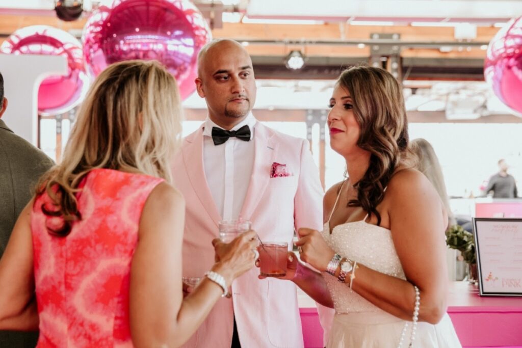 Couple and guests enjoying a candid moment during a celebration, reflecting real moments in South Asian wedding planning